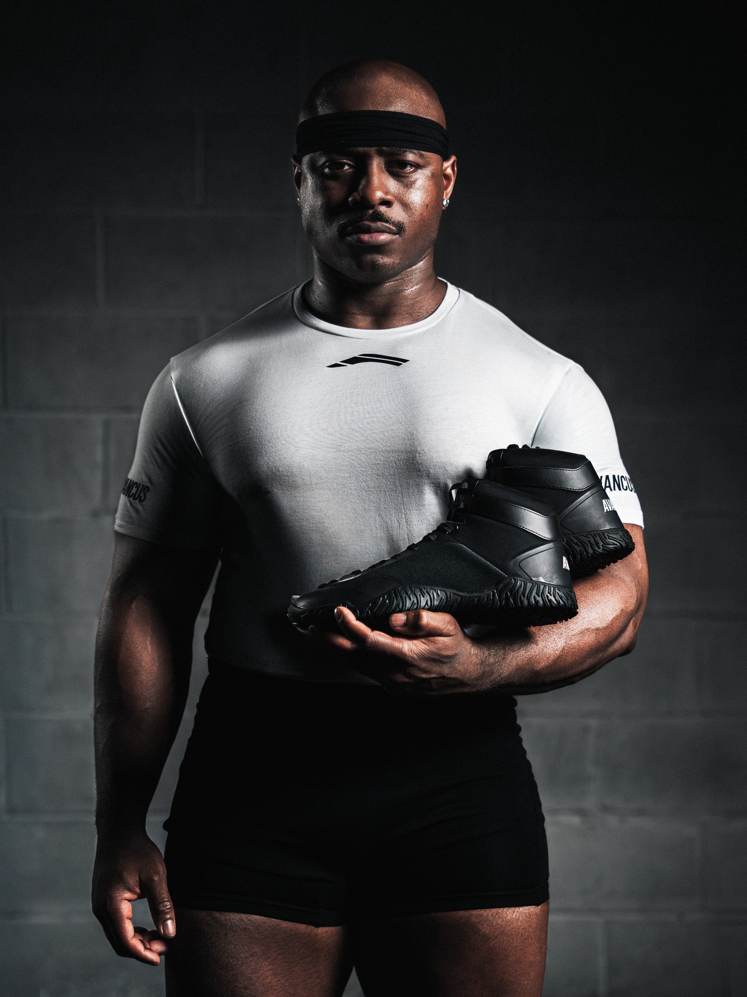 Men’s Competition T-Shirt White – athlete holding Apex Power High Top Black